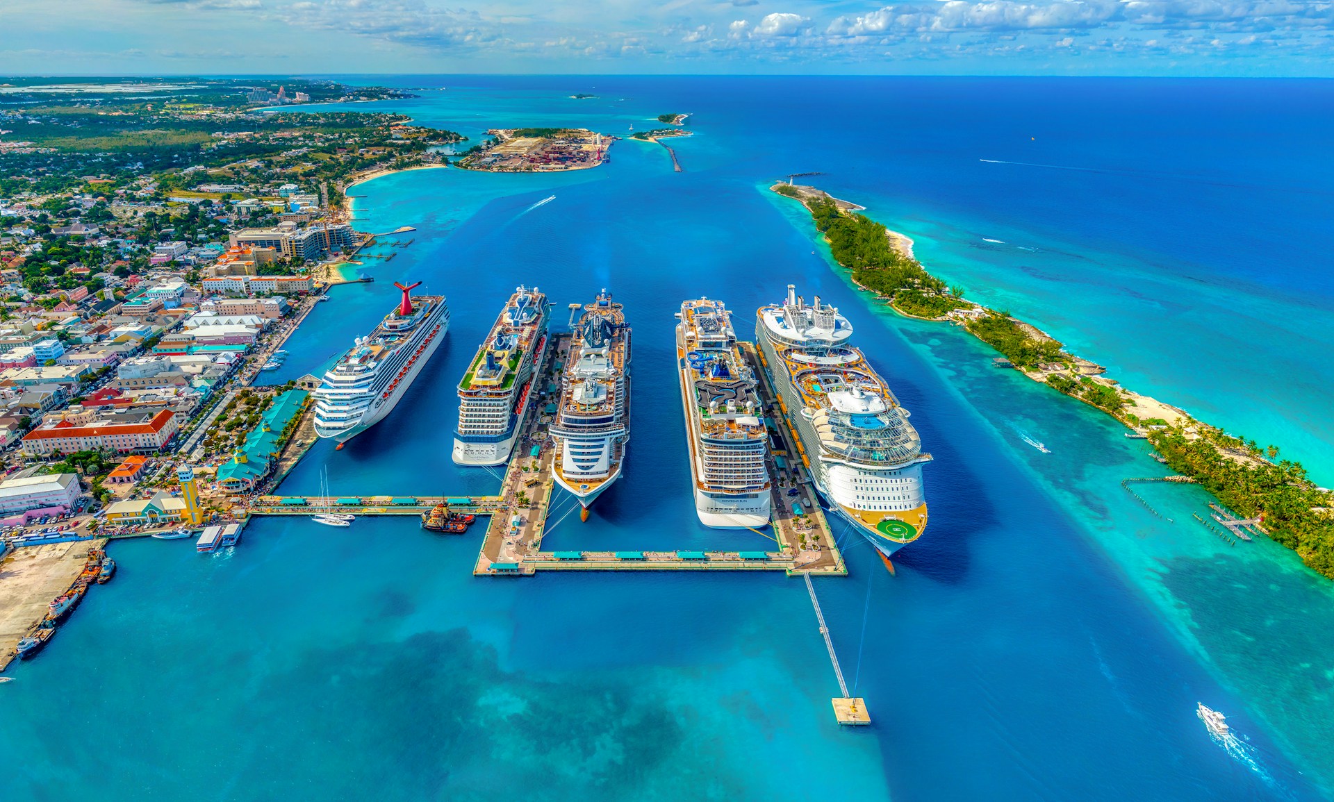 Aerial view of cruise ships docked at a Caribbean port with turquoise waters