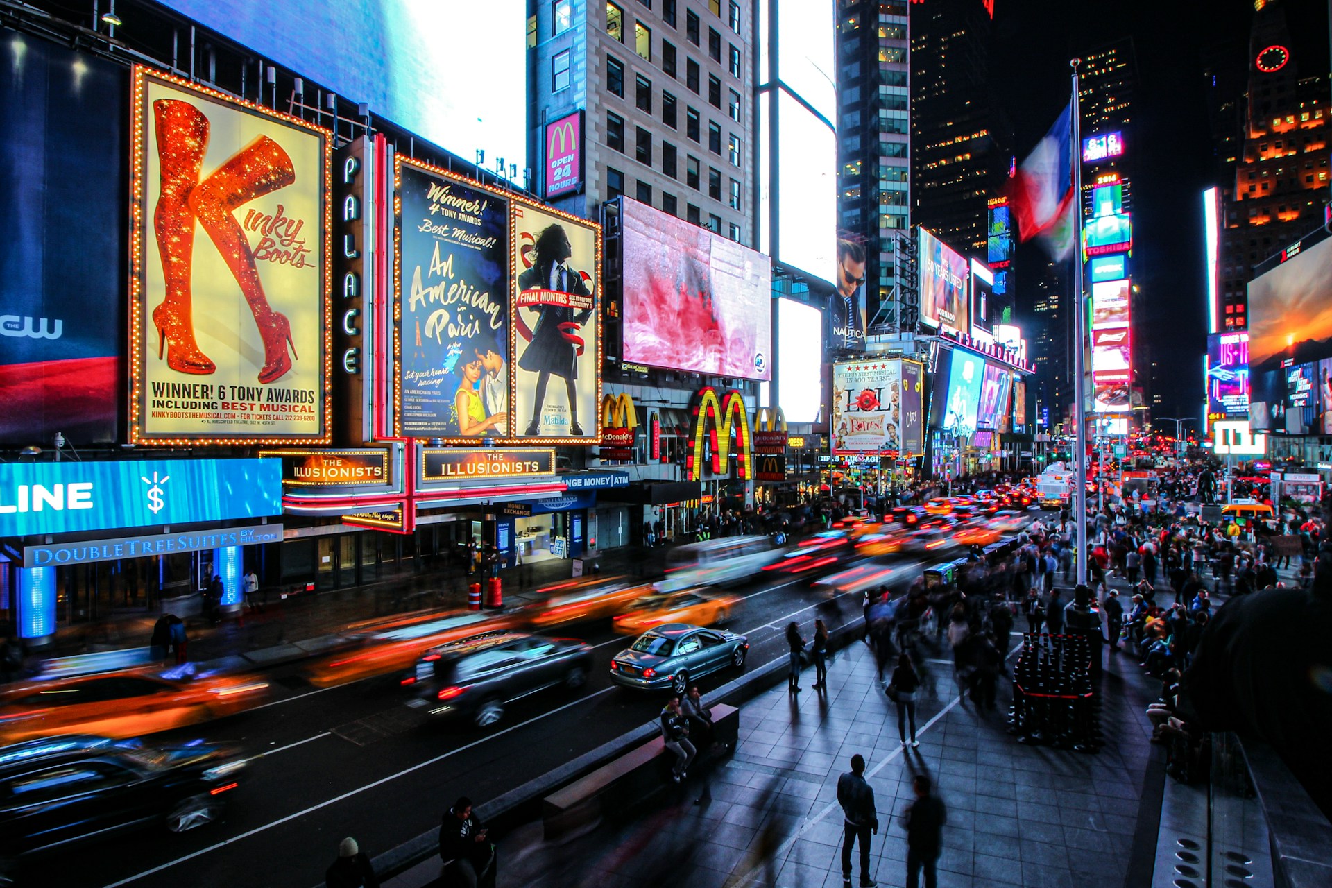 Times Square at night with Broadway show advertisements and bright neon lights