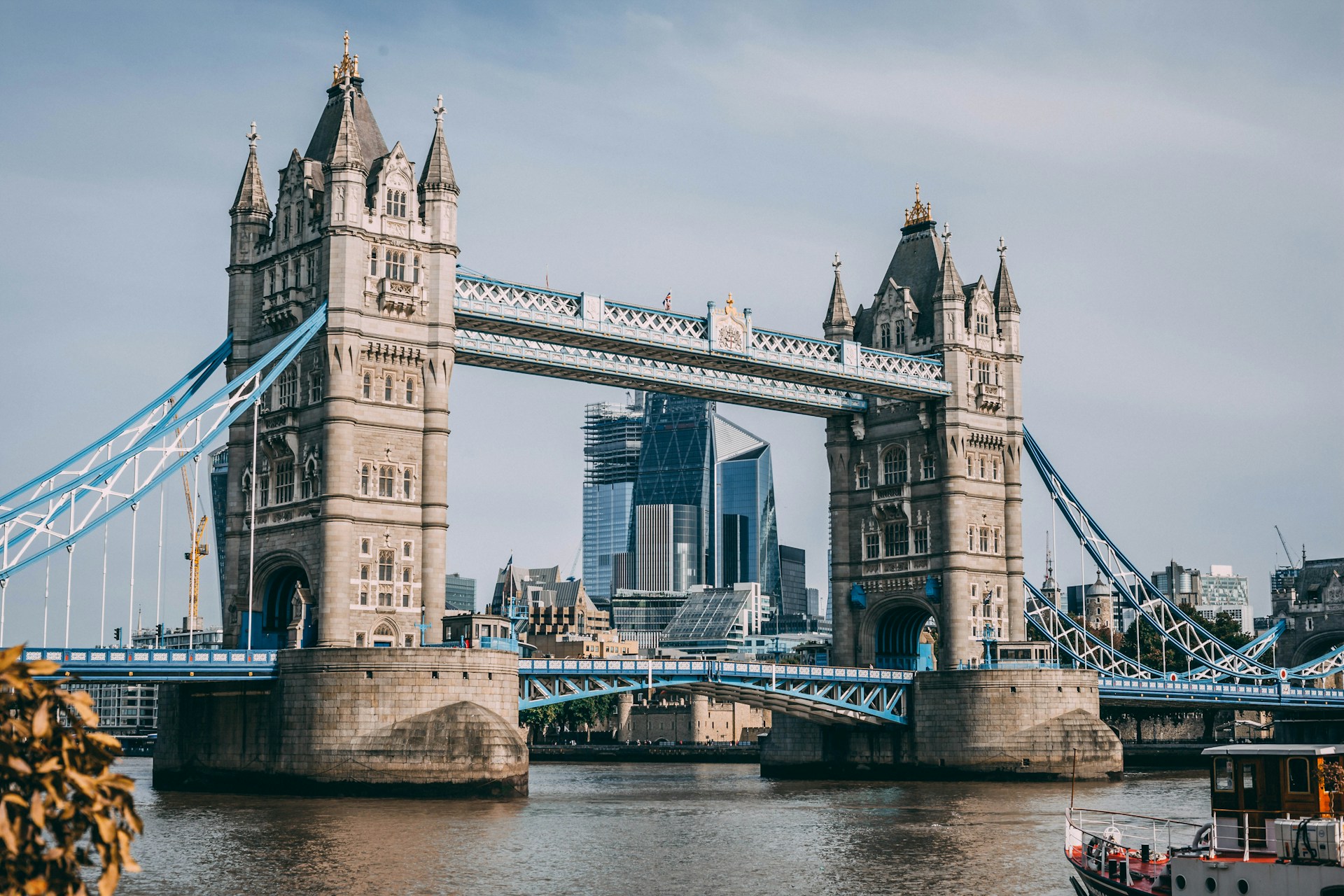 Tower Bridge in London with its iconic blue suspension structure spanning the Thames River